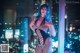 A woman in a fishnet bodysuit posing in front of a window.