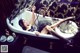 A woman laying in a bathtub with her legs up in the air.